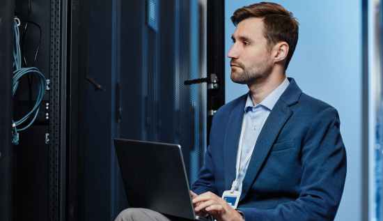 Illustration showing a cloud administrator managing multiple dashboards and servers, representing common cloud management challenges such as security, cost optimization, and performance issues.