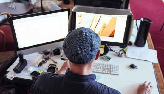 Aspiring 3D modeler working on a digital sculpture with portfolio examples and salary data on screen