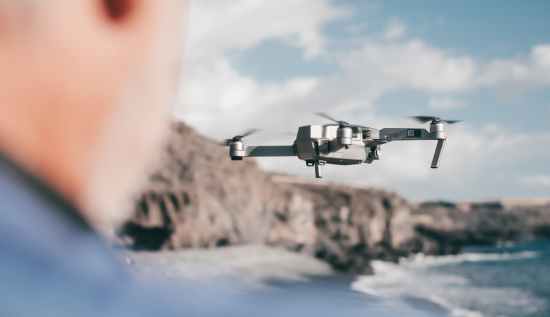 Autonomous drone or AI drone flying overhead with advanced sensor technology.