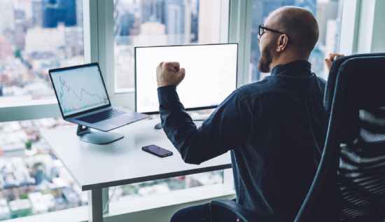 Professional working remotely on a laptop with Power BI dashboards on screen, symbolizing remote data analytics jobs