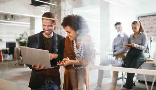 Team of employees using digital workplace tools to enhance productivity and improve digital employee experience