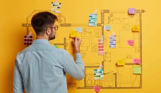 An information architect designing a digital content structure on a touchscreen interface, surrounded by flowcharts, wireframes, and data organization tools.