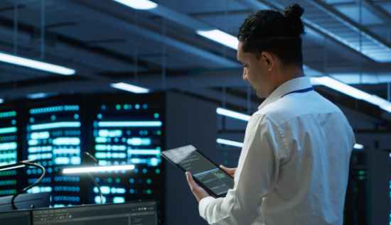 IT technician monitoring server performance to improve system uptime and prevent downtime