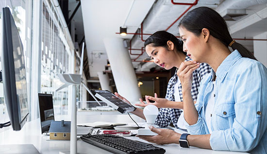 A man is intently working on his laptop, managing IT services, analyzing system performance, troubleshooting technical issues, and coordinating software updates to ensure smooth and secure operations.