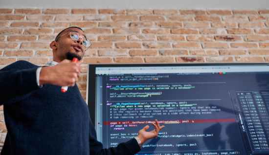 Developer working with neural network architecture visualizations alongside Rust and C++ code snippets, representing programming beyond Python.