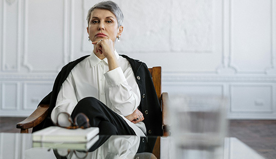 Business intelligence consultant analyzing data dashboards and graphs on a digital screen.