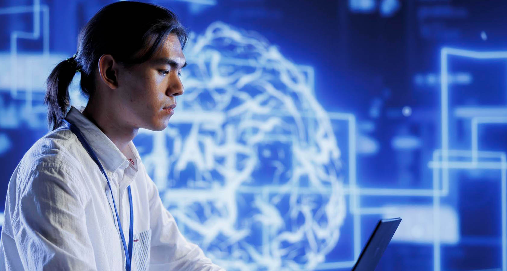 A man gazes at his laptop, exploring the world of computer science.