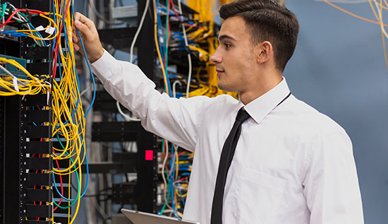 System administrator monitoring network servers and troubleshooting issues