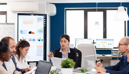 Business team sitting at table in office are talking about Importance of Integrating Technology into Business Strategy